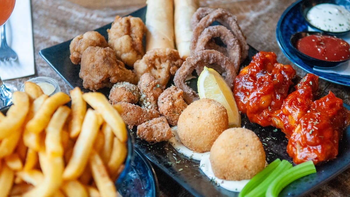 A share platter of wings, arancini, onion rings and chips at Father's Office