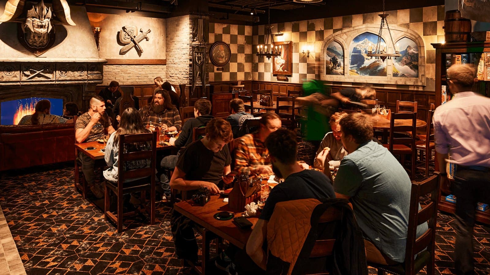 Tables of people playing board games in the Fortress tavern