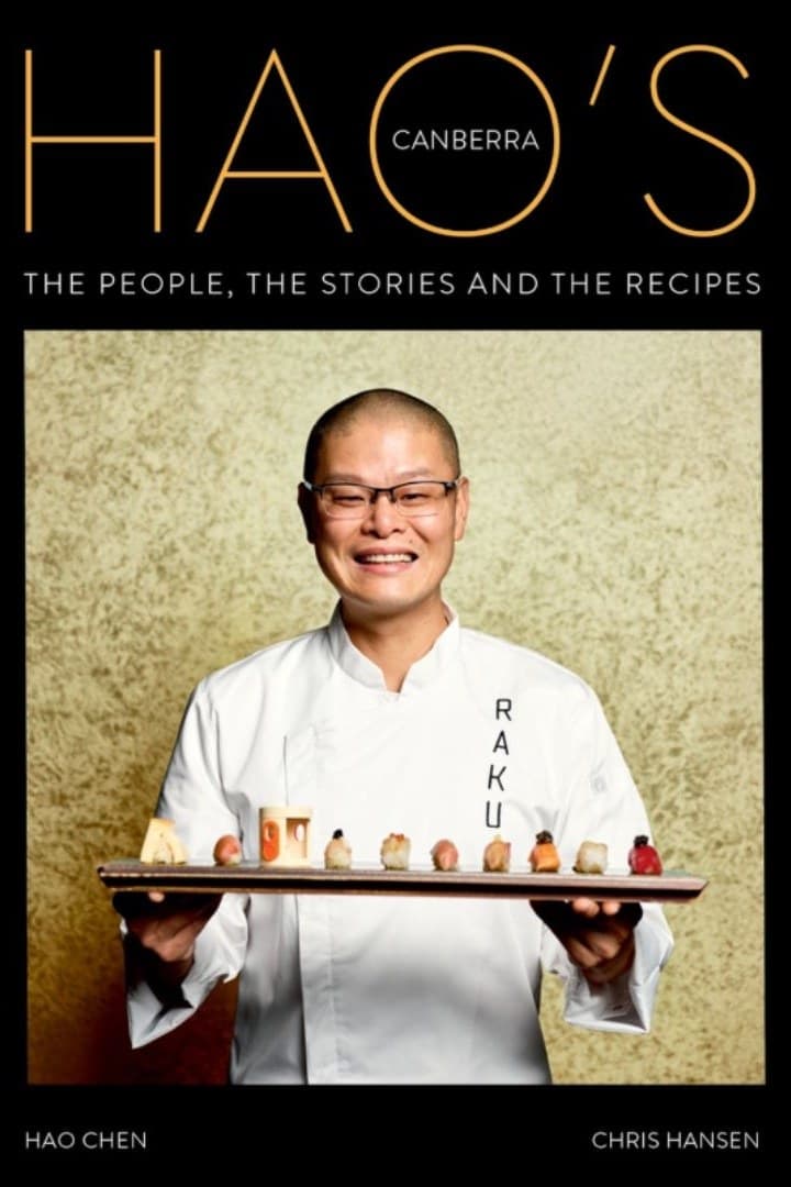 The cover of Hao's Canberra, showing chef Hao Chen in Raku whites holding a board of nigiri